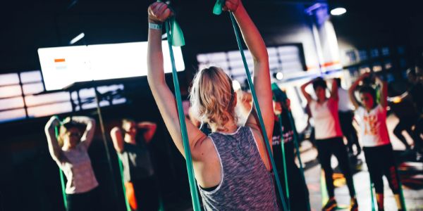 group using a resistance band as triceps pushdown