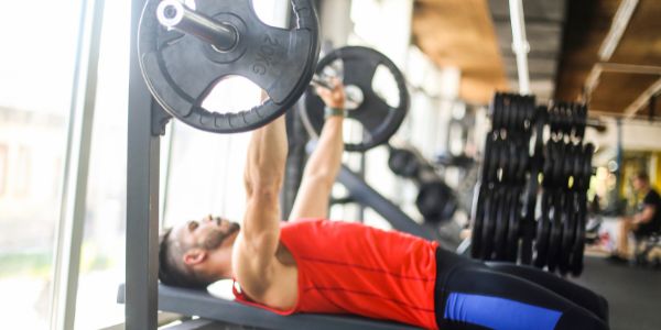 man doing Close grip bench press at the gym